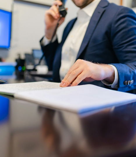 a man sitting at a desk writing on a piece of paper